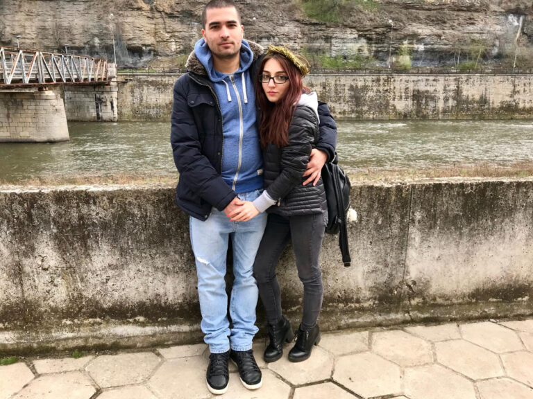Portrait of young couple standing by river